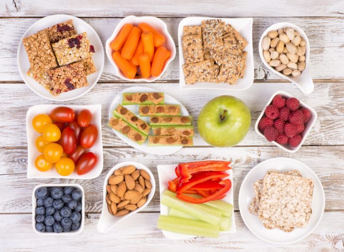 Healthy snacks on wooden table, top view
