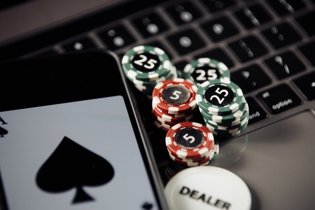 poker-play-online-concept-poker-chips-playing-cards-smartphone-keyboard_253401-360