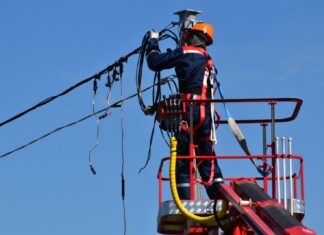 5 Tricks To Help You Survive During A Long Power Outage man in red and black jacket wearing orange helmet