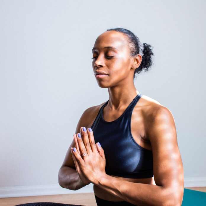 Photo by madison lavern woman wearing black sports bra