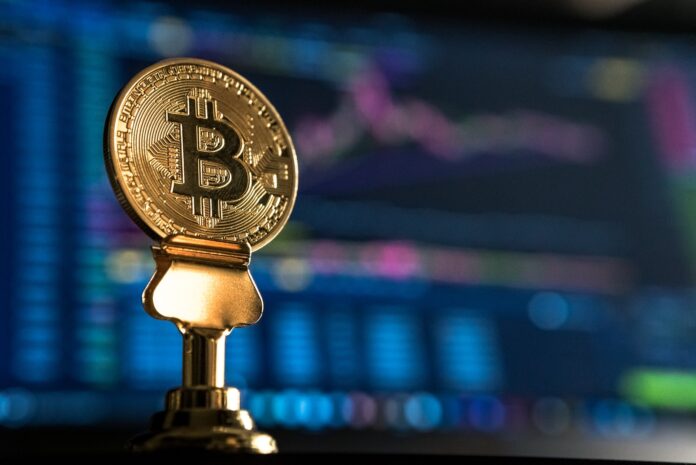 Photo by André François McKenzie selective focus photo of Bitcoin near monitor
