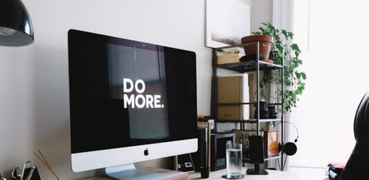 The Relationship Between Social Media and TV silver iMac with keyboard and trackpad inside room