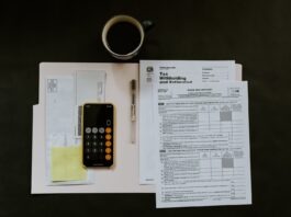 What Parents Should Know About a TFSA black Android smartphone near ballpoint pen, tax withholding certificate on top of white folder