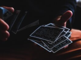 What to consider when playing online baccarat? person playing with cards