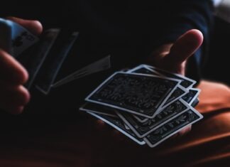 What to consider when playing online baccarat? person playing with cards