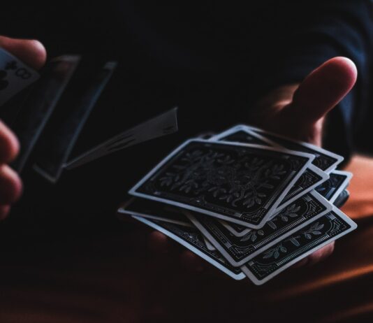What to consider when playing online baccarat? person playing with cards