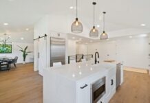 Best Home Upgrades to Try in 2022 turned on pendant lamps above kitchen island