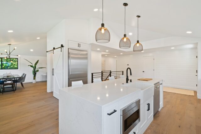 Photo by Im3rd Media turned on pendant lamps above kitchen island