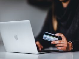 Mobile Banking – An Easy and Convenient Way to Manage Your Money woman holding black smartphone near silver macbook
