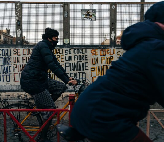 The Beginners Guide on How to Learn Italian From Scratch man in black jacket riding red bicycle