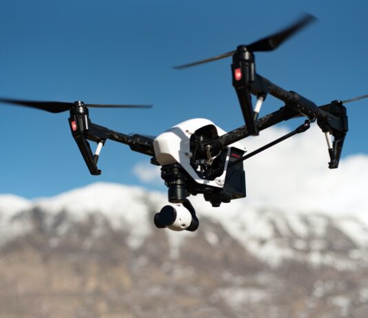 Mistakes to Avoid While Buying Remote Control Helicopters white and black quadcopter hovering under blue skies