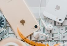 How To Use Face ID To Unlock iPhone While Wearing a Mask gold iPhone 7 beside white Apple EarPods and silver iPhone 5s