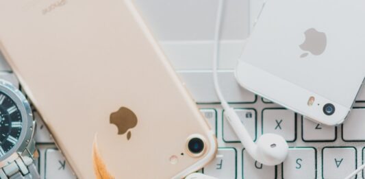 How To Use Face ID To Unlock iPhone While Wearing a Mask gold iPhone 7 beside white Apple EarPods and silver iPhone 5s