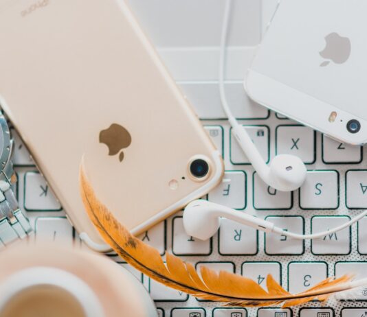 How To Use Face ID To Unlock iPhone While Wearing a Mask gold iPhone 7 beside white Apple EarPods and silver iPhone 5s