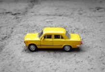 Learning The Impact Of Your Car Insurance When You Scrap Your Vehicle yellow sedan die-cast on gravel