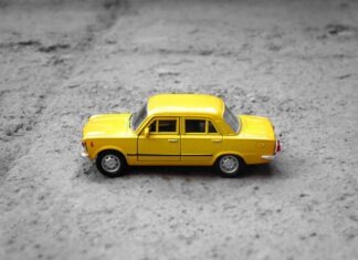 Learning The Impact Of Your Car Insurance When You Scrap Your Vehicle yellow sedan die-cast on gravel