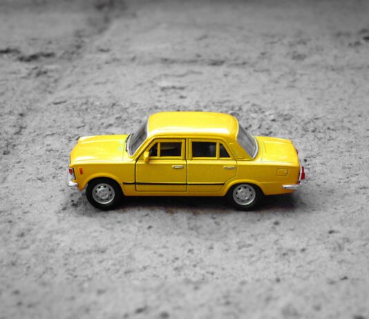 Learning The Impact Of Your Car Insurance When You Scrap Your Vehicle yellow sedan die-cast on gravel