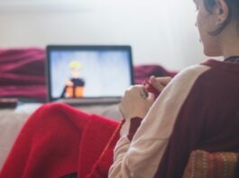 The Best Anime to Watch on Crunchyroll woman in red sweater sitting on chair