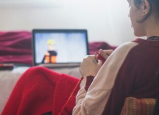 The Best Anime to Watch on Crunchyroll woman in red sweater sitting on chair