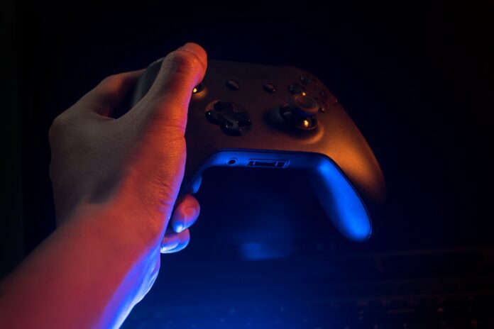 a-picture-containing-remote-person-indoor-contr A picture containing remote, person, indoor, control Description automatically generated