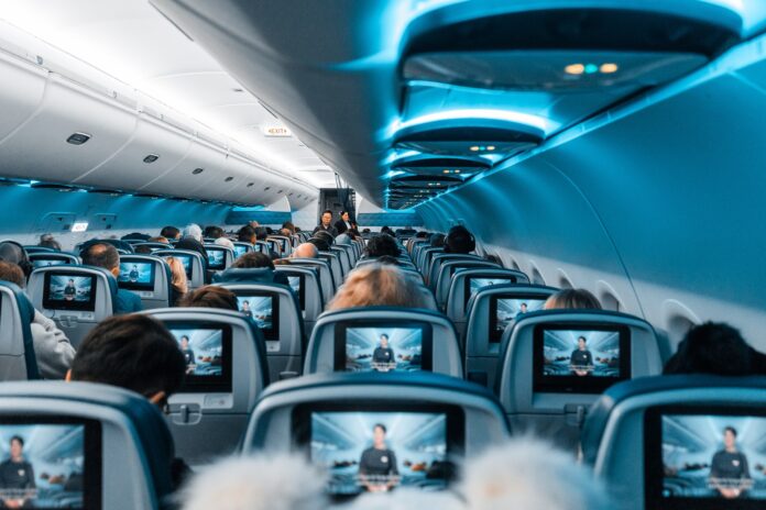 Photo by Omar Prestwich people in airplane during daytime
