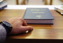 How to Find a Good Personal Injury Lawyer Online person holding black covered book on brown wooden table