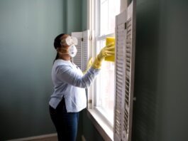 Natural Ways to Neutralize Odor in Your Home woman in white long sleeve shirt and blue denim jeans standing beside white wooden framed glass