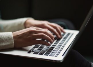 How to Become a Book Editor in 6 Easy Steps person using laptop