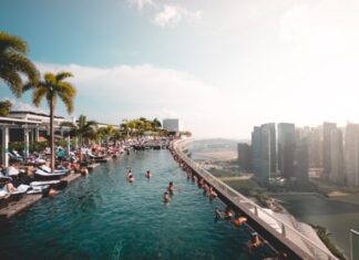 How to Keep Your Swimming Pool Safe: Tips for First-Time Hotel Managers group of people at the swimming pool under white clouds