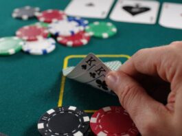 The 3 Casino Games Everyone Needs to Try person holding white and black playing cards