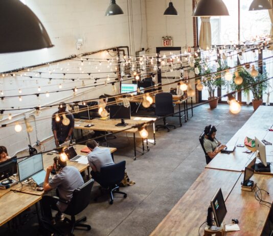 How to Scale IT Business in 2022 people sitting in front of computer monitors