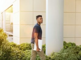 Six Basic Reasons Why College Students Become Unemployed man holding laptop walking towards building