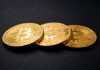 Bitcoin Prime the Automated Software three gold-colored bitcoins on black surface