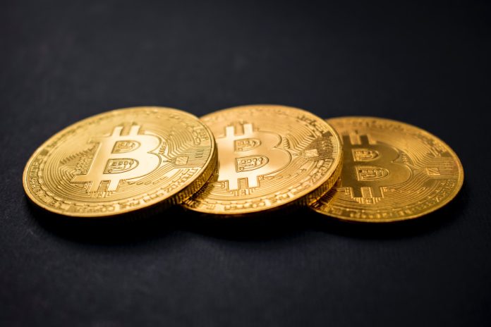Photo by Dmitry Demidko three gold-colored bitcoins on black surface
