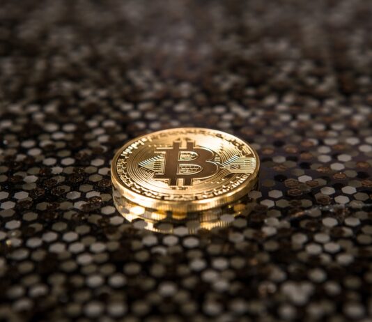 Progress of Bitcoin Mining in Nebraska gold-colored Bitcoin coin on ground