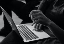 History and Development Trends of Online Casinos grayscale photo of person using MacBook