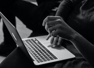 History and Development Trends of Online Casinos grayscale photo of person using MacBook