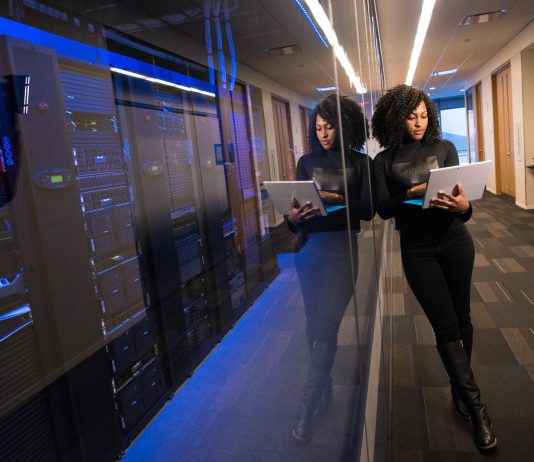 How Technology Impacts Business Operations woman in black top using Surface laptop