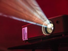 Projector and Screen Rental for Outdoor Movie Party turned on LED projector on table