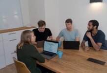 Are Digital Sales Rooms The Future of B2B Sales? group of people sitting on chair in front of brown wooden table