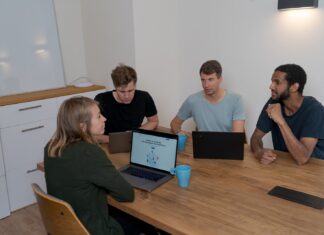 Are Digital Sales Rooms The Future of B2B Sales? group of people sitting on chair in front of brown wooden table