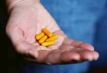 Attraction To Drugs: Understanding The Problem And Overcoming It Successfully yellow medication pill on persons hand