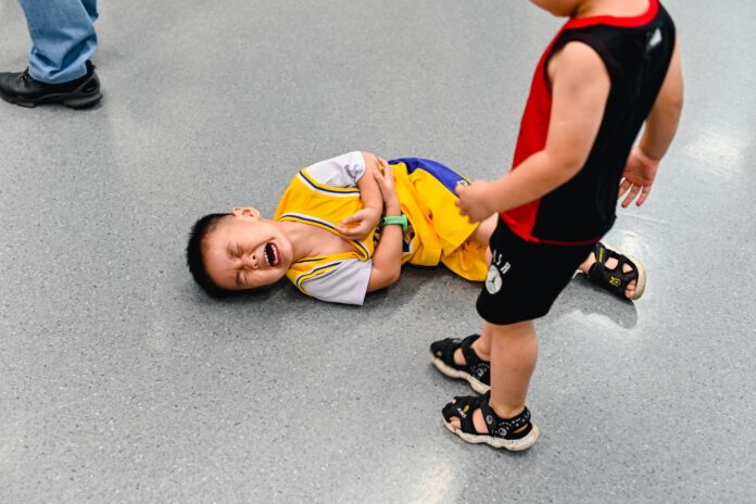 Photo by yang miao 2 boys lying on the ground