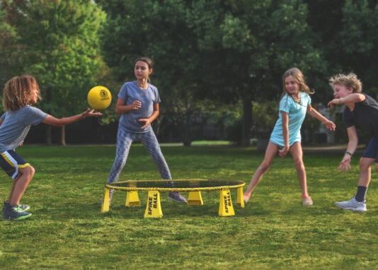 Readjusting to Life Post-Pandemic: How to Help Your Kids 2 women playing soccer on green grass field during daytime