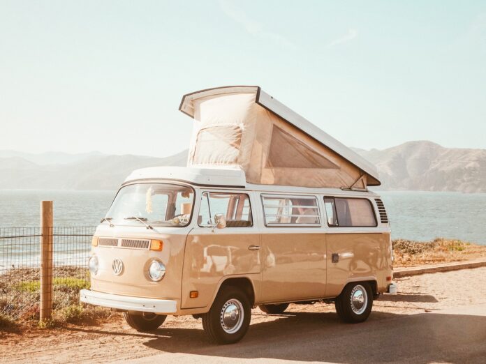 Photo by Caleb George brown Volkswagen T1 van near body of water at daytime