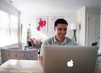 Investing Secrets 101: Unusual Ways of Making Money man in gray hoodie sitting on chair in front of silver macbook