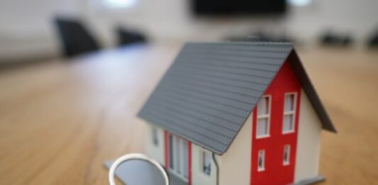 Calculating the Average Amount of House Insurance With Surex white and red wooden house miniature on brown table