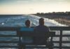 Retirement Plan 101: Getting Ready to Retire man and woman sitting on bench in front of beach