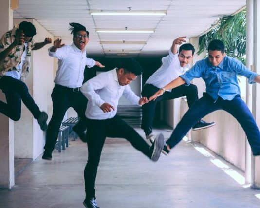 How to Improve Employee Experience group of people doing jump shot photography