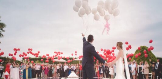 Considerations to Make for Your Wedding photo of a man and woman newly wedding holding a balloons